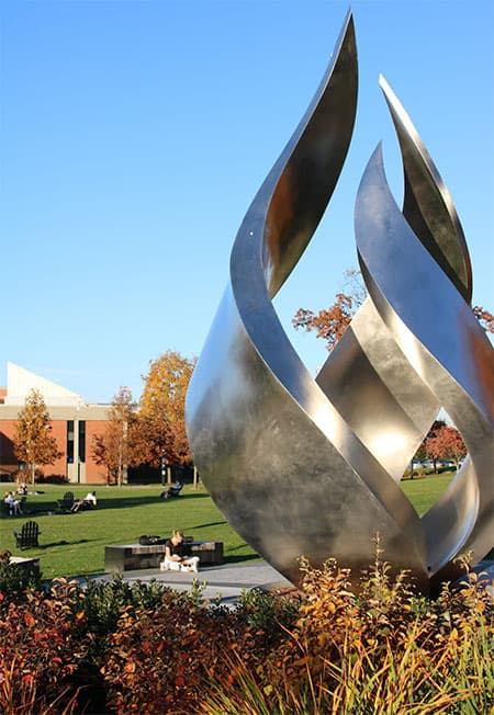 The torch statue on the Slavin center lawn on a sunny fall day